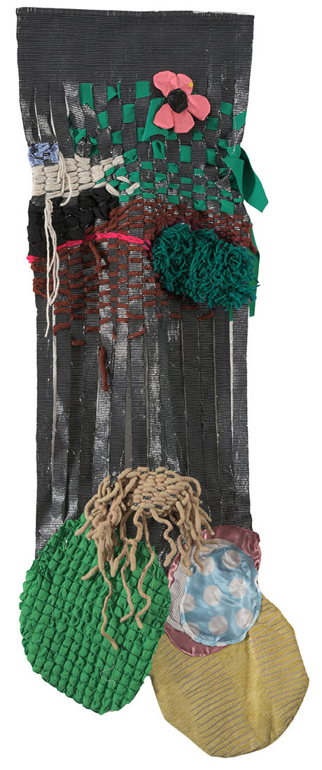Colorful textile art piece featuring woven fabrics and three-dimensional embellishments, showcasing various textures and shapes.