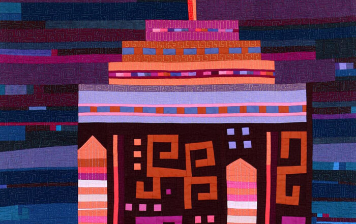 Colorful abstract quilt design featuring geometric patterns in vibrant shades of purple, orange, and pink, evoking a lively and artistic aesthetic.