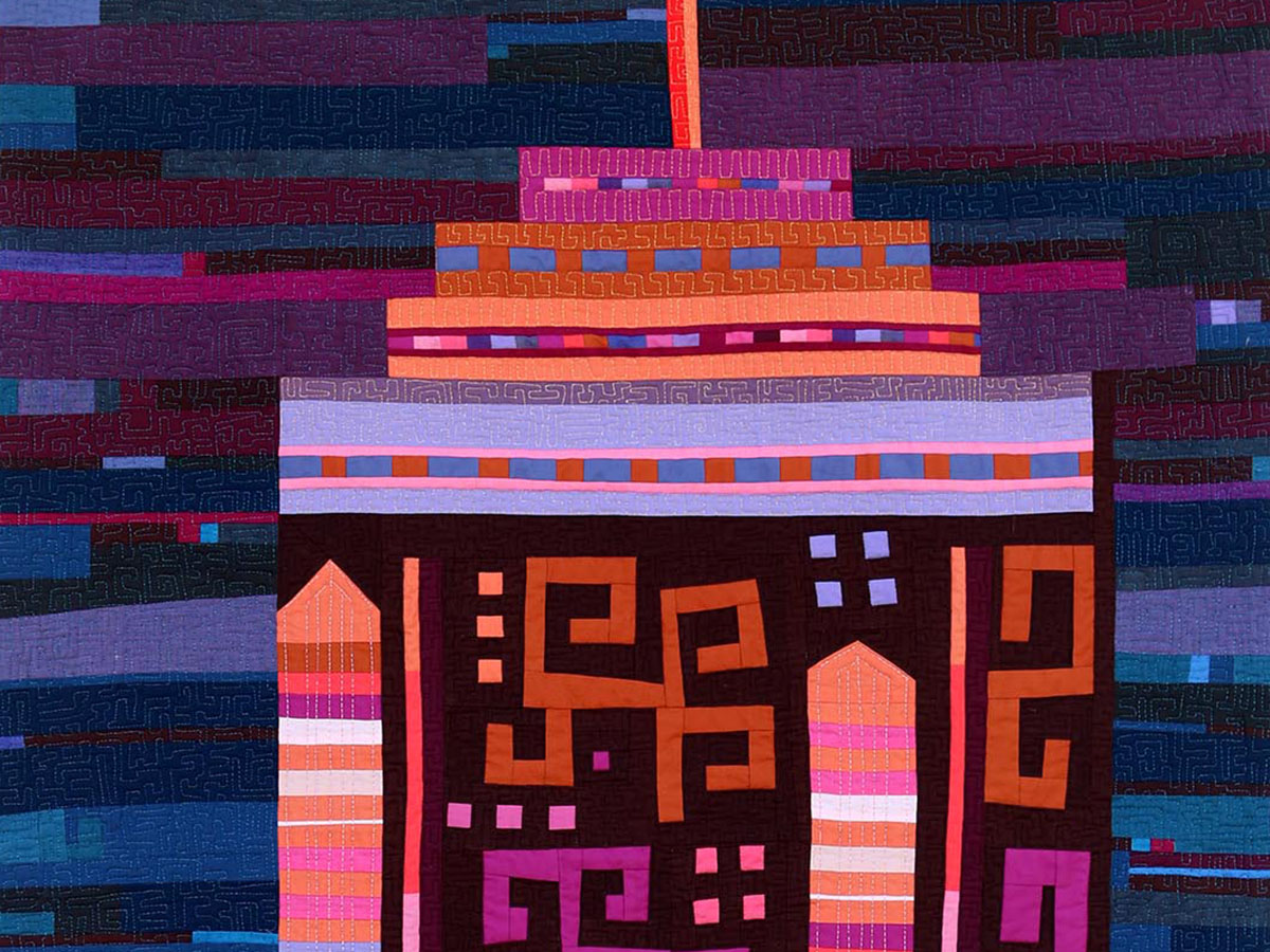 Colorful abstract quilt design featuring geometric patterns in vibrant shades of purple, orange, and pink, evoking a lively and artistic aesthetic.