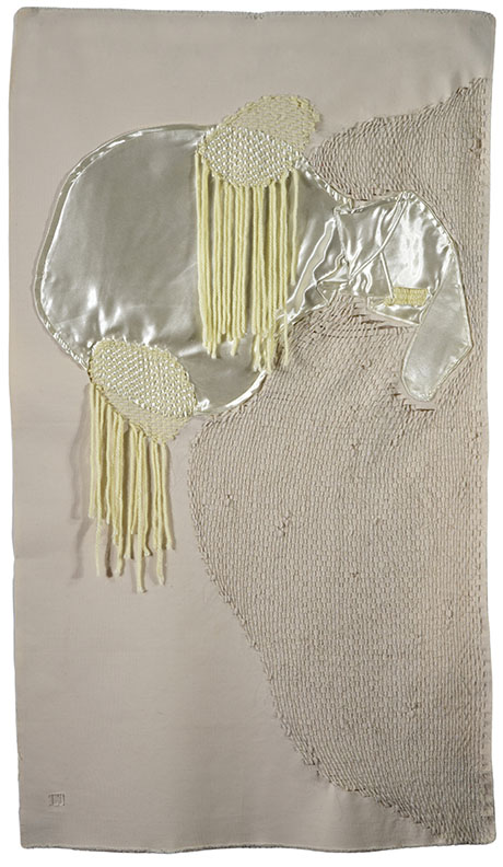 Abstract textile art featuring smooth silver fabric with yellow fringe accents on a textured beige background.