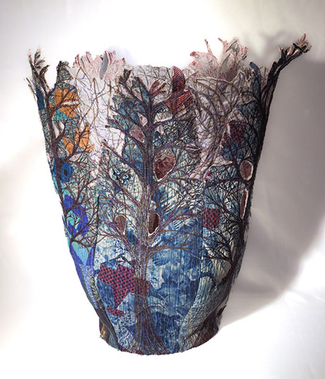 A textured, colorful textile sculpture depicting trees and nature, with intricate patterns and a flowing, organic shape. A textured, colorful textile sculpture depicting trees and nature, with intricate patterns and a flowing, organic shape.