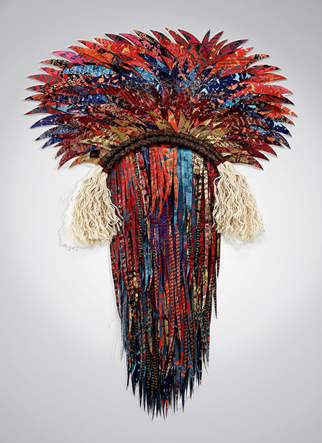 Colorful feather headdress with vibrant red, blue, and gold tones, adorned with textured fringes and decorative white tassels. Colorful feather headdress with vibrant red, blue, and gold tones, adorned with textured fringes and decorative white tassels.