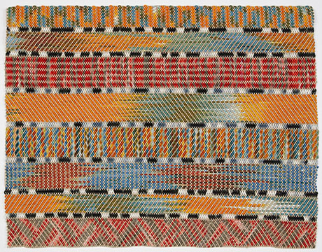 Colorful woven textile featuring bold stripes of orange, blue, red, and black with intricate geometric patterns throughout. Colorful woven textile featuring bold stripes of orange, blue, red, and black with intricate geometric patterns throughout.