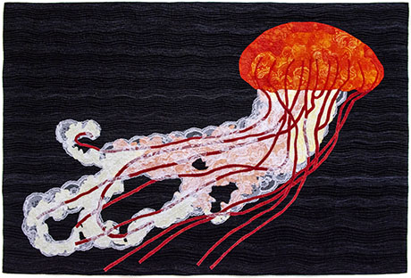 Artistic textile depicting a vibrant orange jellyfish against a textured black background, showcasing flowing tentacles and ethereal patterns.