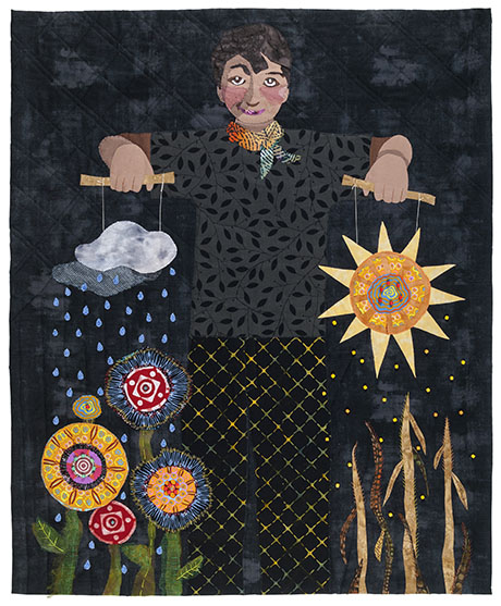 A textile artwork features a smiling person holding a sun and a raincloud like marionettes. Vibrant flowers bloom under the rain, wheat grows under the sun.