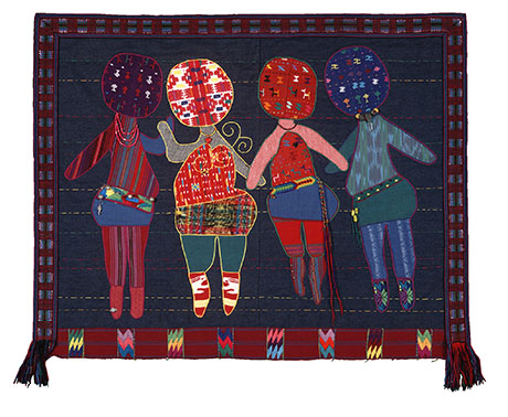 A colorful textile art piece by Kathleen McCabe shows three abstract, faceless figures with patterned clothing on a dark backdrop, conveying unity and vibrancy.
